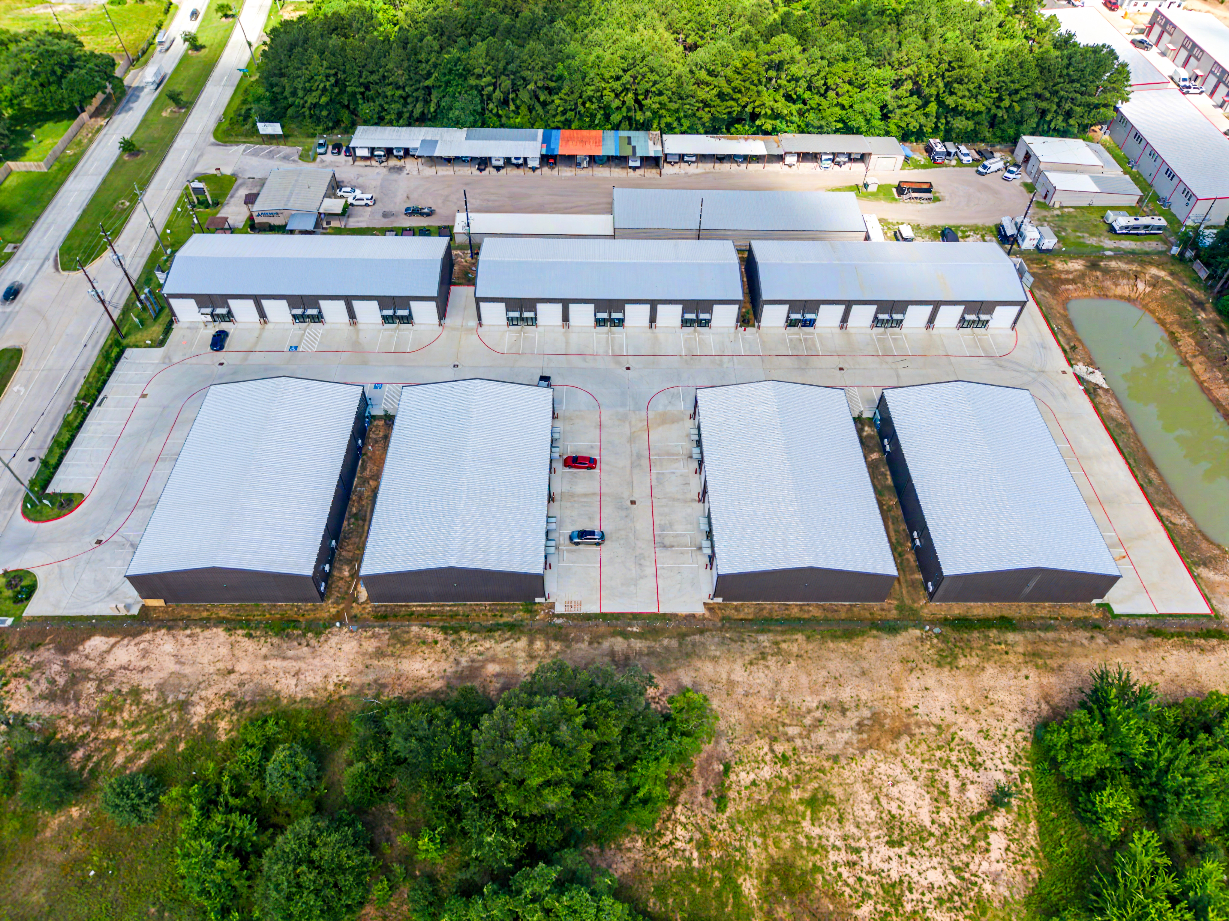 Aerial photograph of a Houston commercial warehouse complex and pond