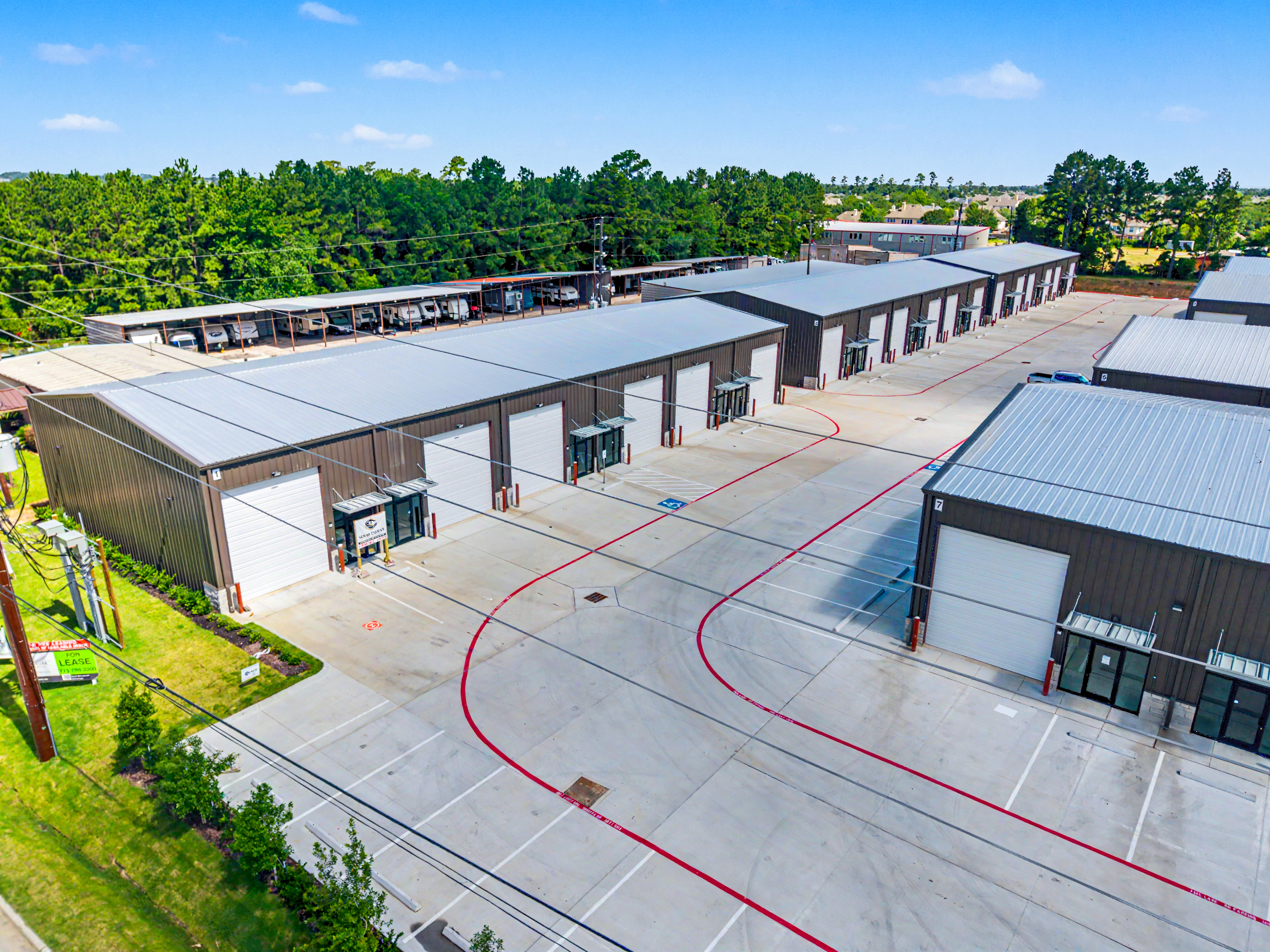 Aerial photograph of a commercial warehouse row with parking