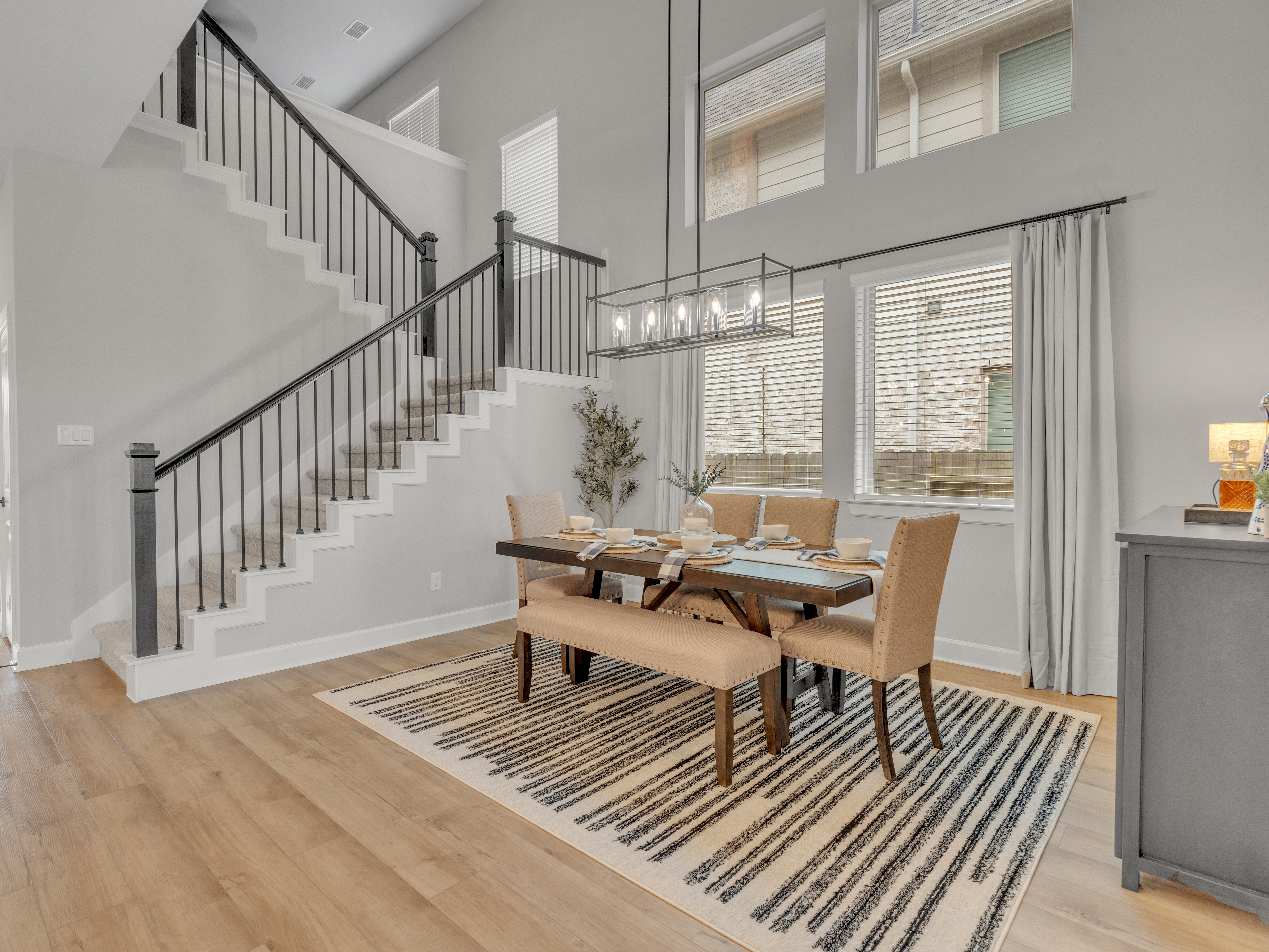 Dining room with staircase and pendant chandelier