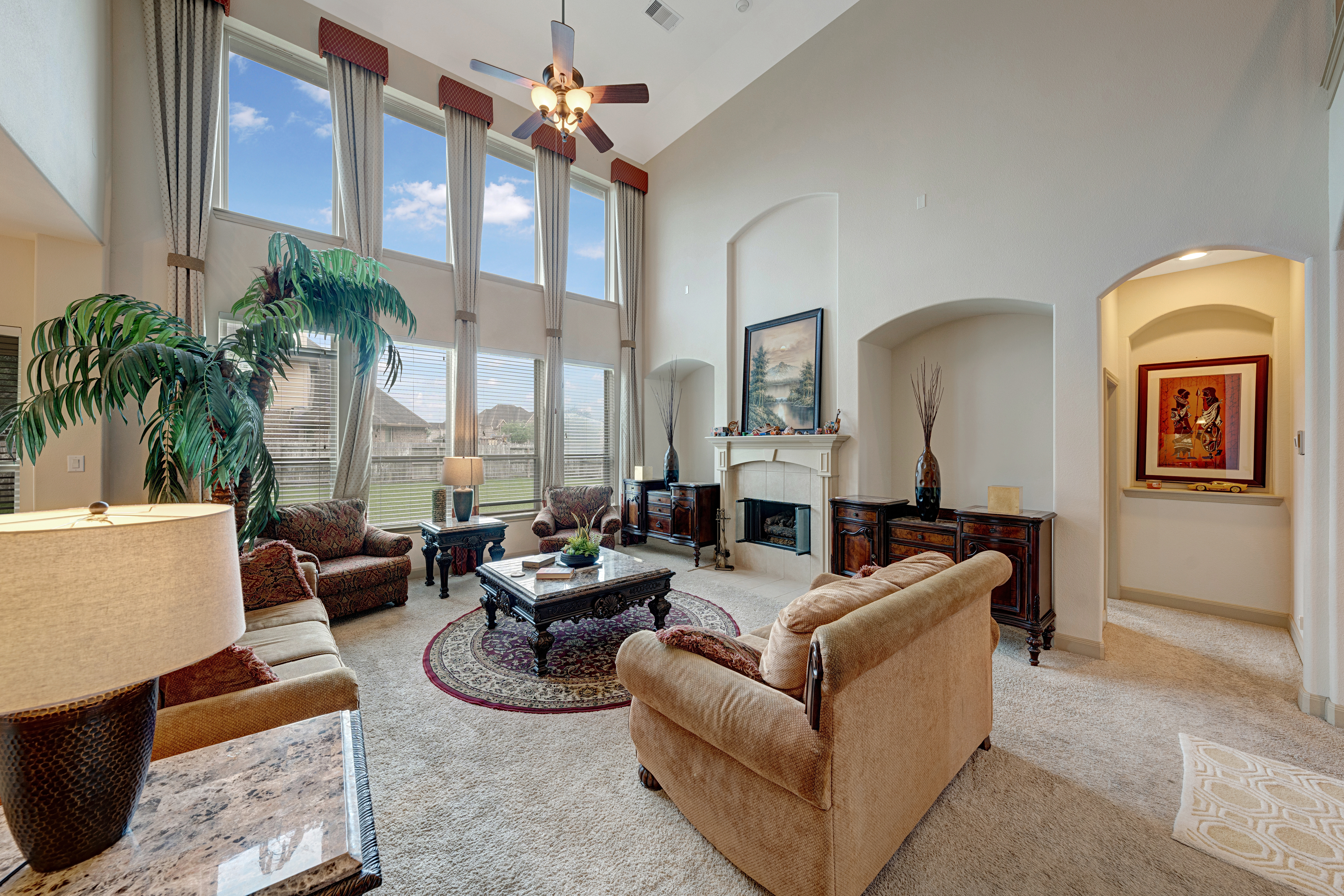 Living room with fireplace and archway views