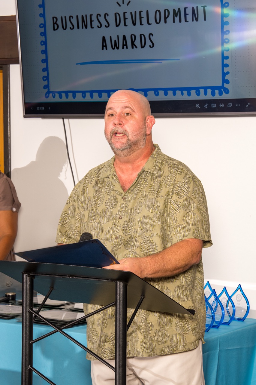 Speaker addressing guests at a business development awards event