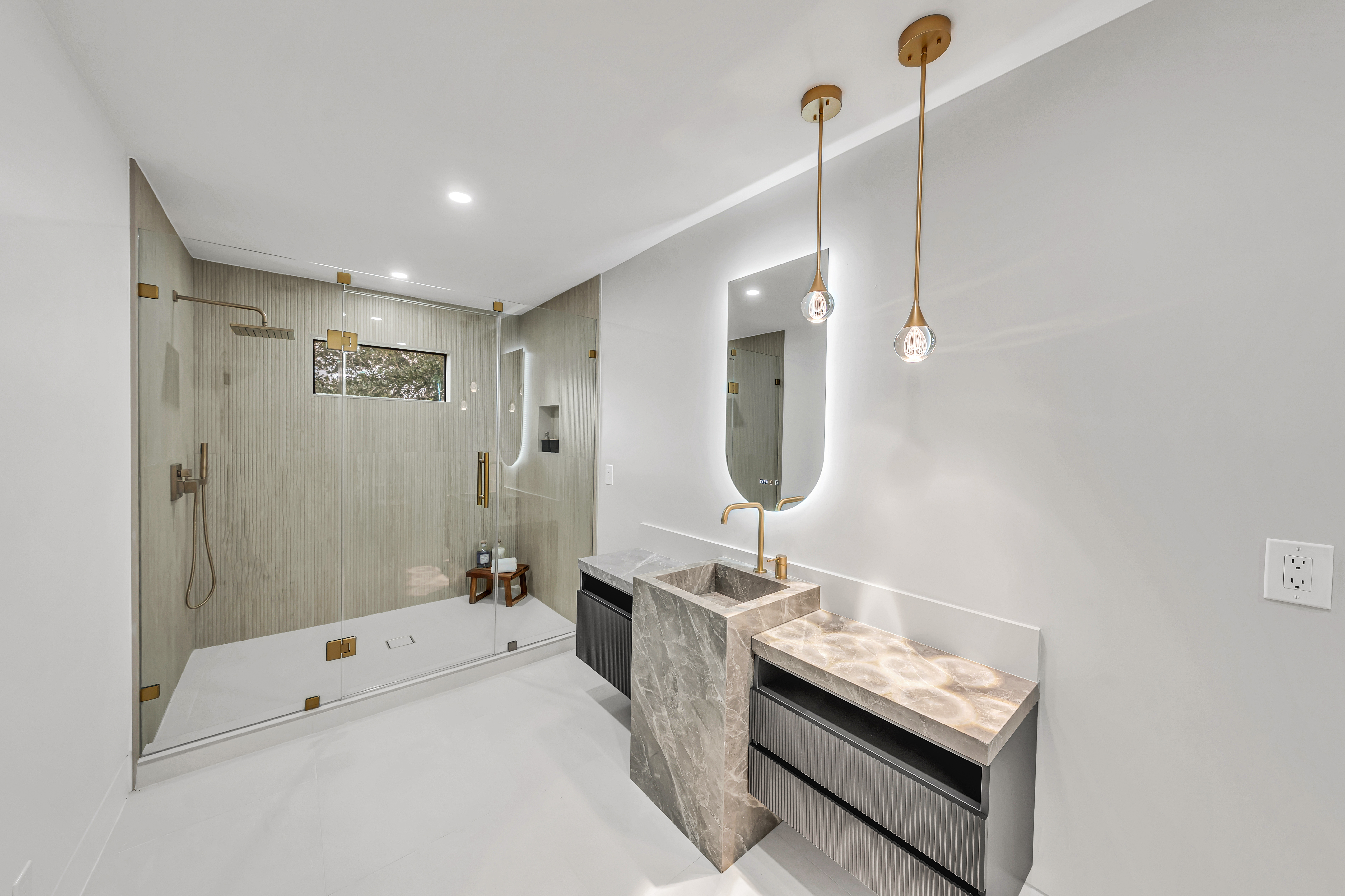 Modern bathroom with brass fixtures and glass shower