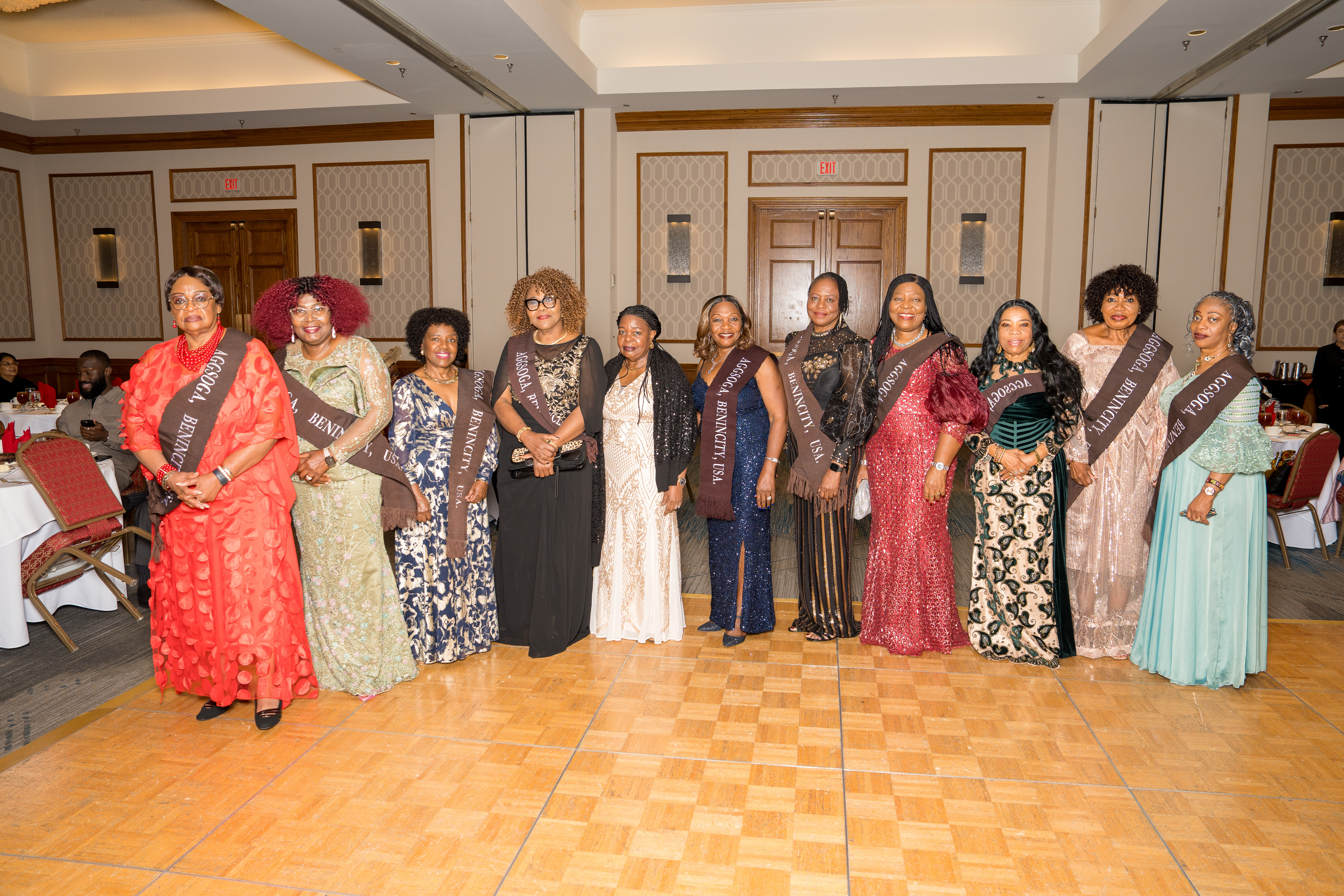 Line of gala guests wearing sashes at an award ceremony