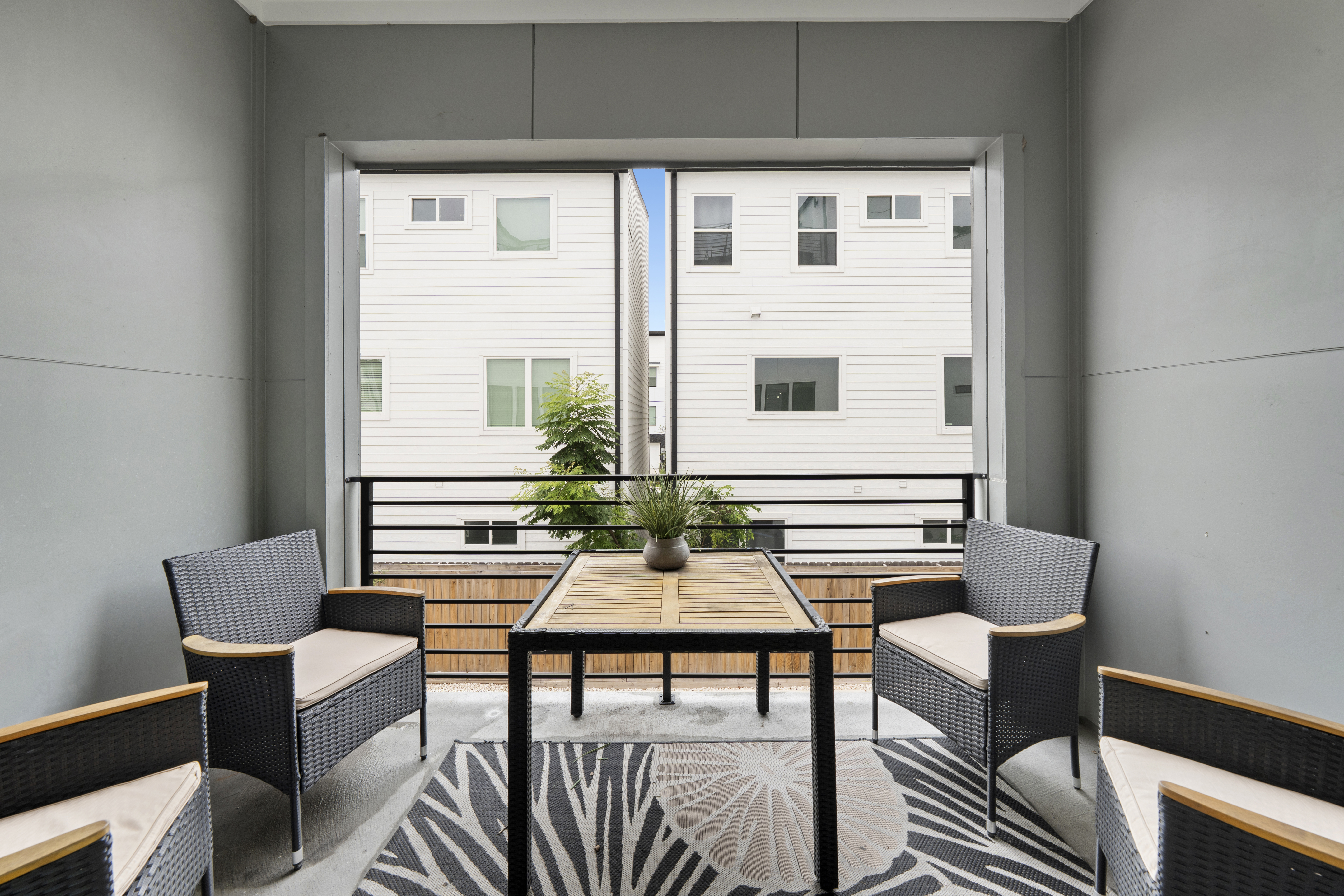 Covered balcony seating area with woven furniture