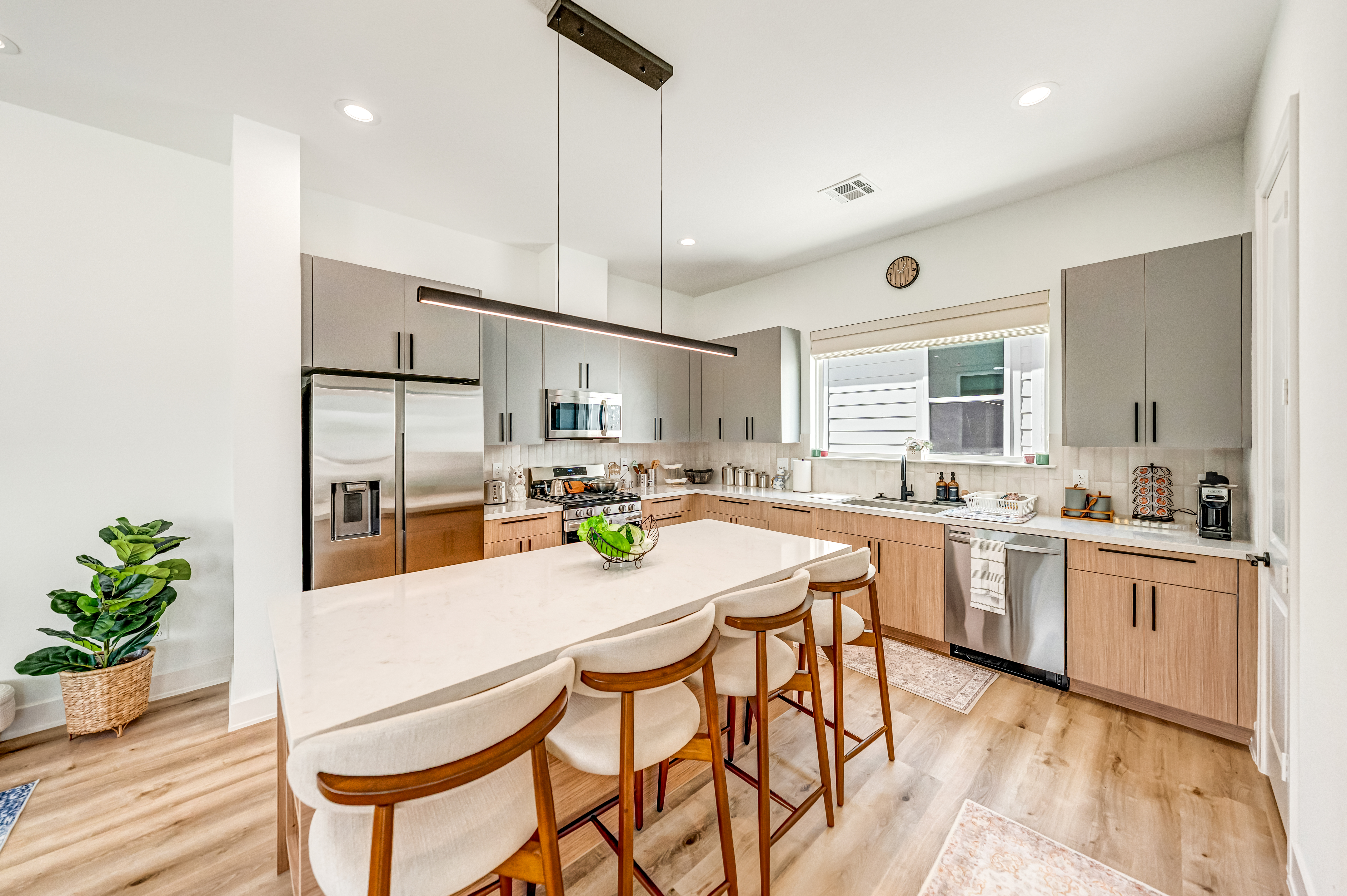 Bright kitchen with wood cabinets and island seating