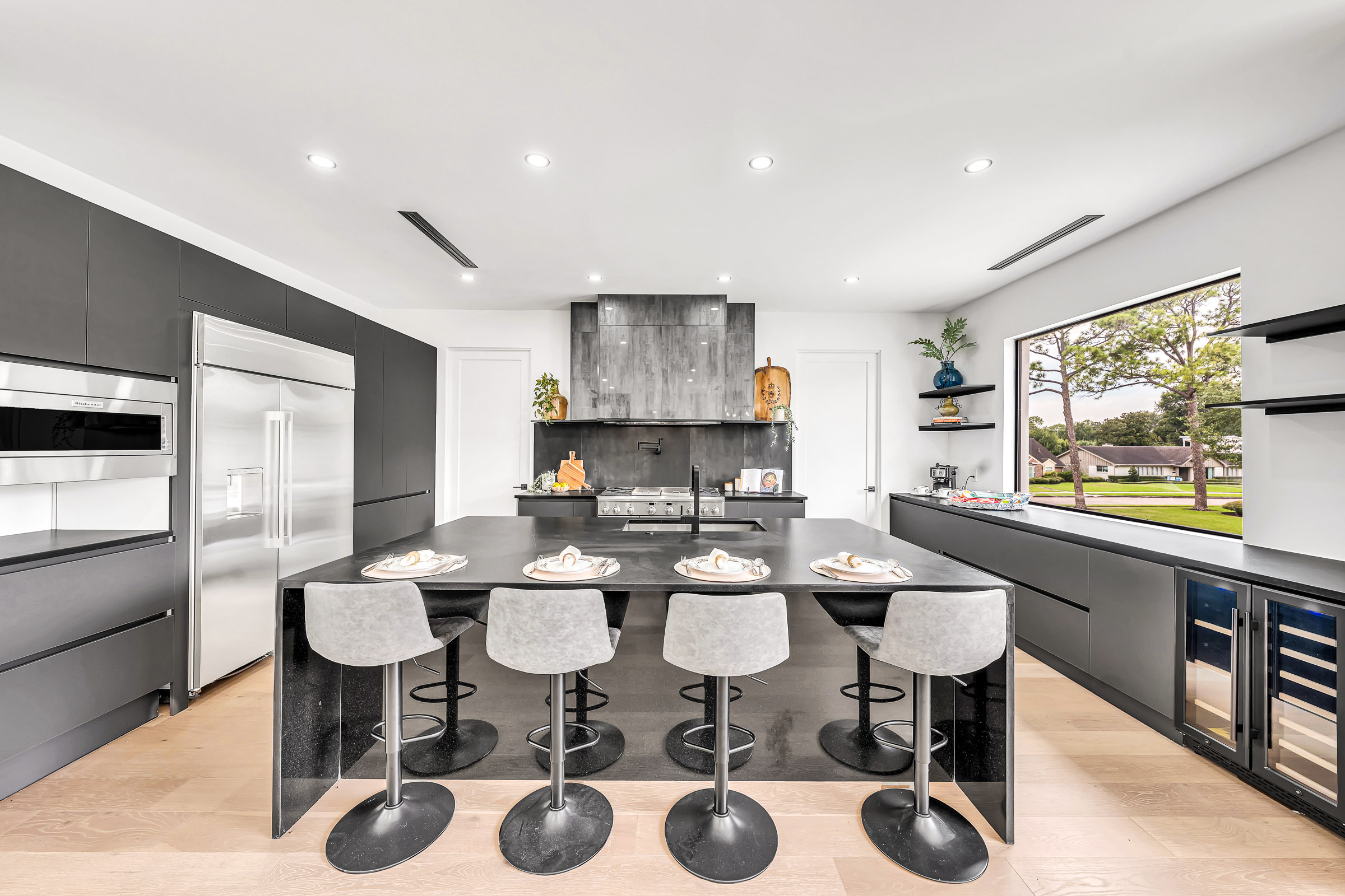 Open-concept kitchen with marble island, fireplace and dining area