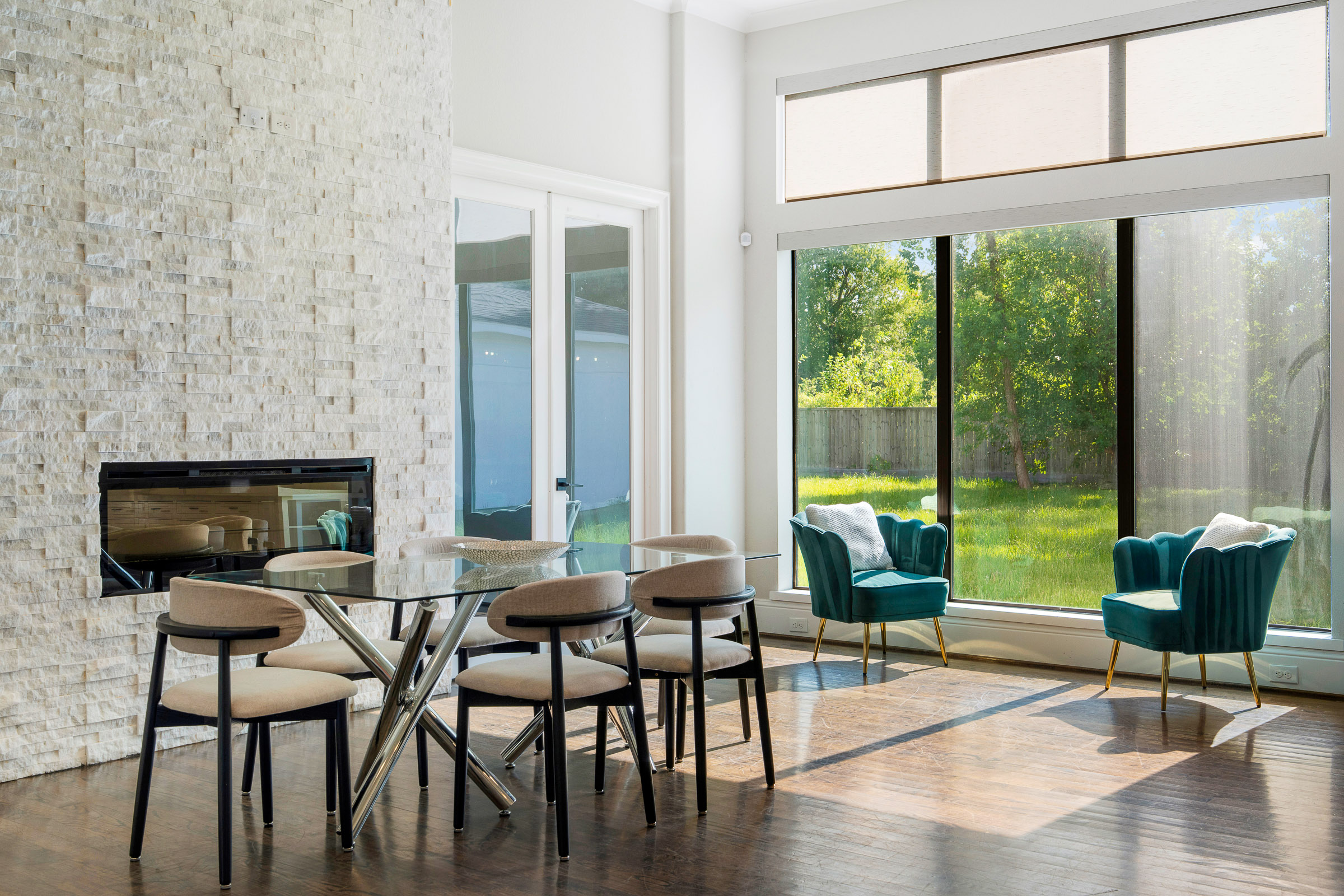 Modern dining room with globe pendant cluster and backyard view