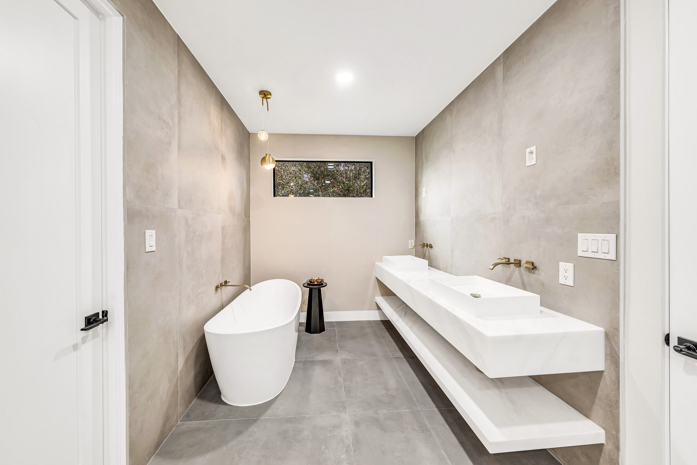 Spa bathroom with freestanding tub and floating stone vanity